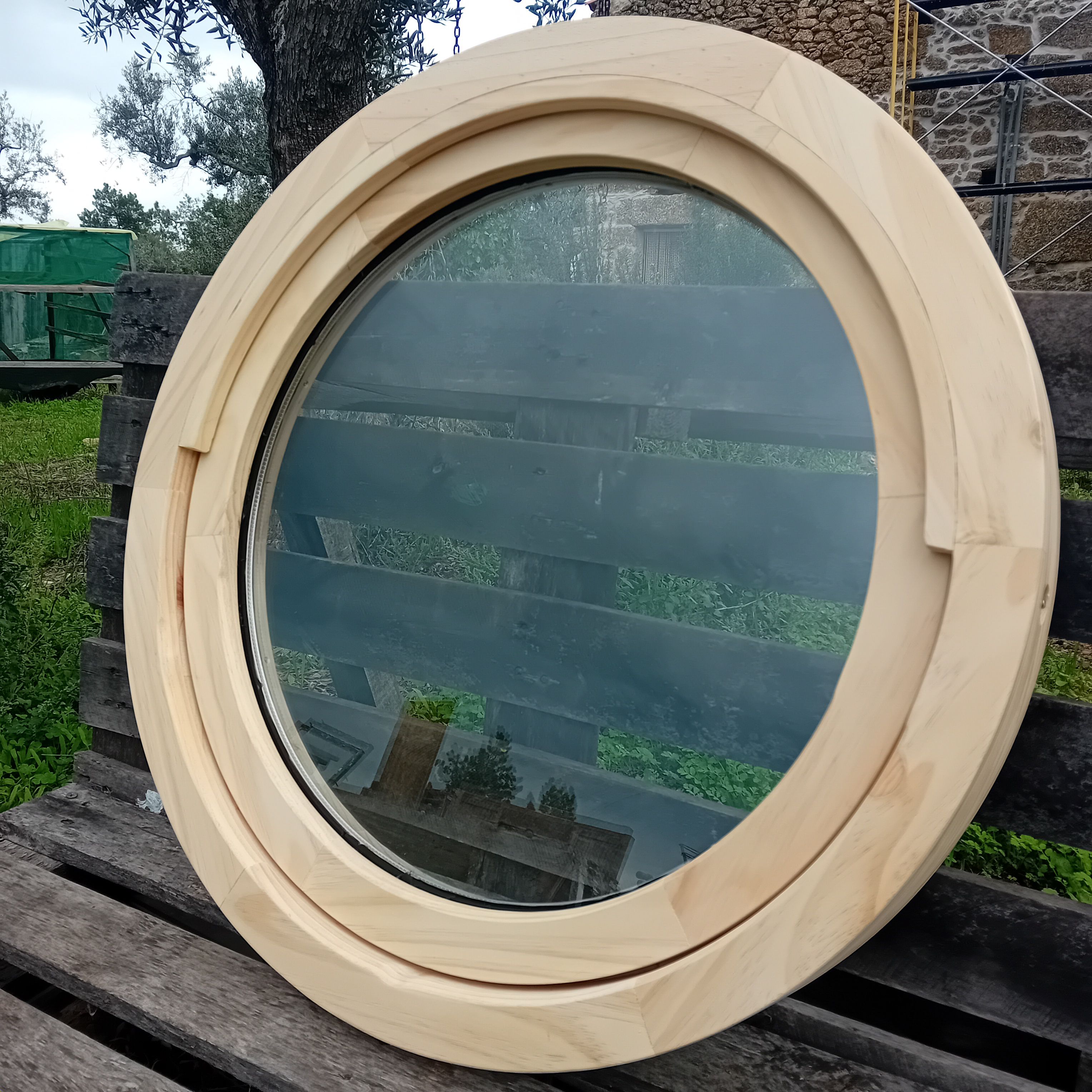 Round wooden window with pale wood